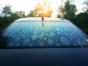 Rear window of a car showing air bubbles in cheap tint—similar low standards apply to cheap paint protection. Diamond Detailing Perth delivers professional paint protection