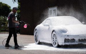Wax is Dead ceramic coating Perth – Installer snowfoaming a Porsche coated with Ultimate Plus.
